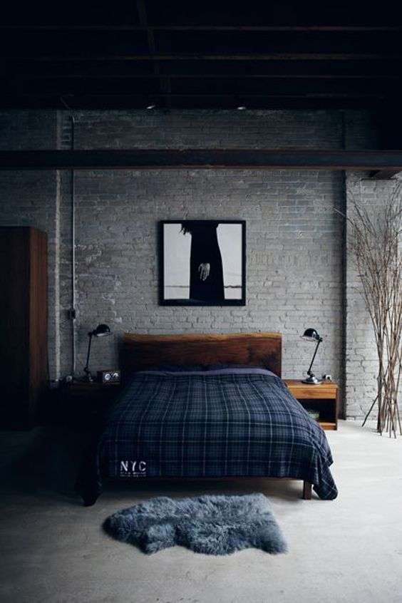 Camera da letto con parete in mattoni