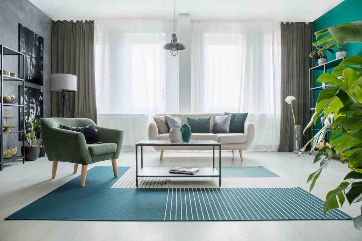 soggiorno con salotto arredato con tappeto blu