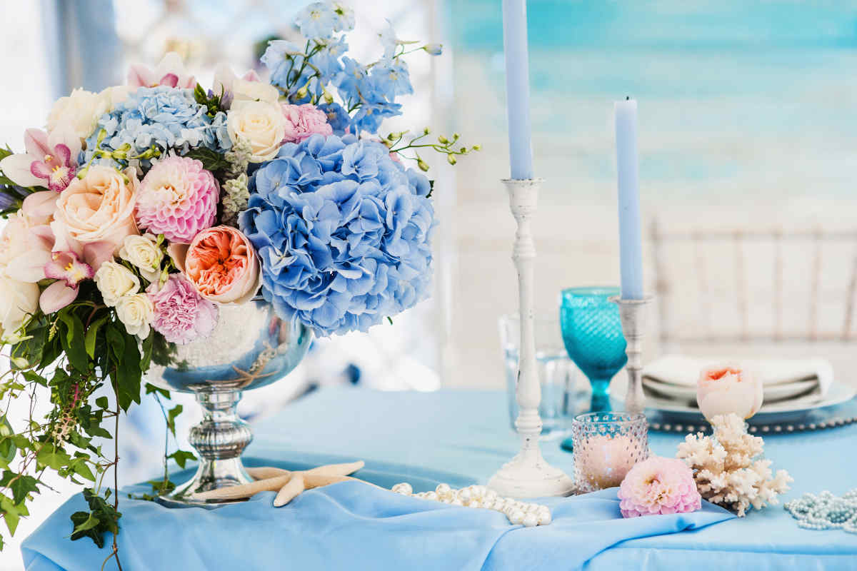 tavola apparecchiata nei toni del blu con decorazioni floreali