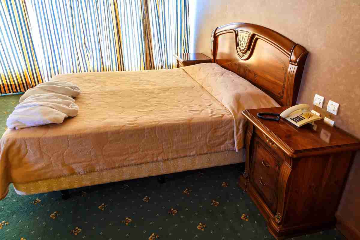 camera da letto vintage con letto e testiera in legno