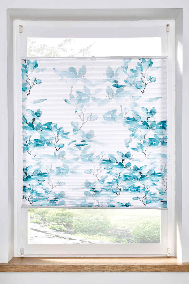     Window with pleated curtain with blue floral motifs