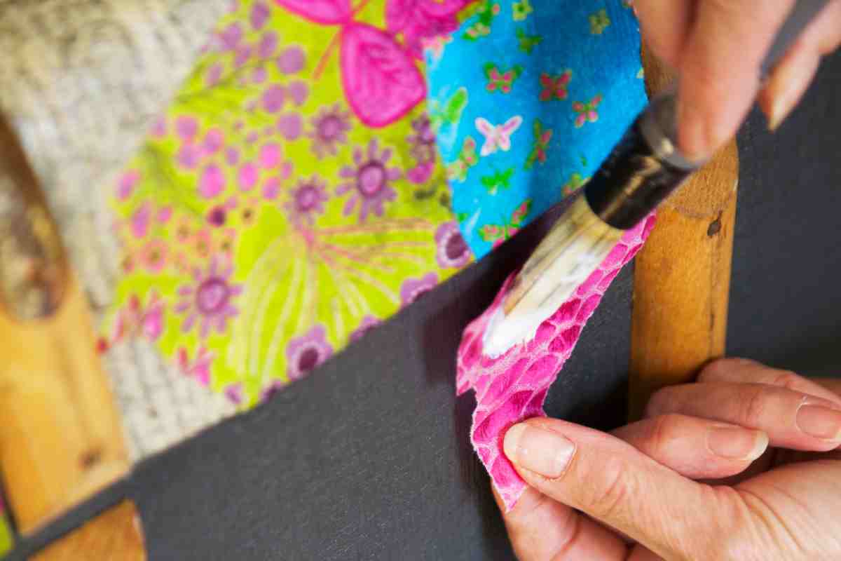 focus su pennello e carta applicata con la tecnica del Découpage