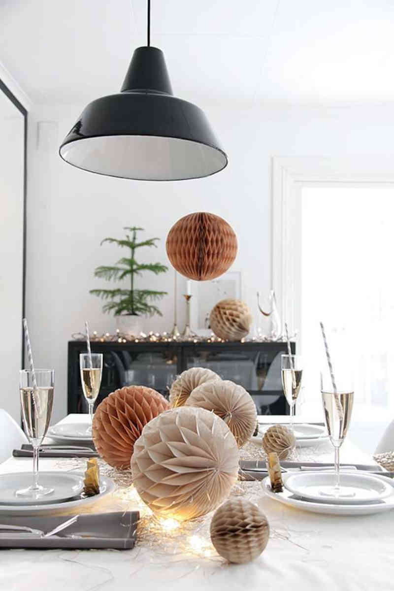 tavola di capodanno decorata in modo elegante con luci e sfere di carta