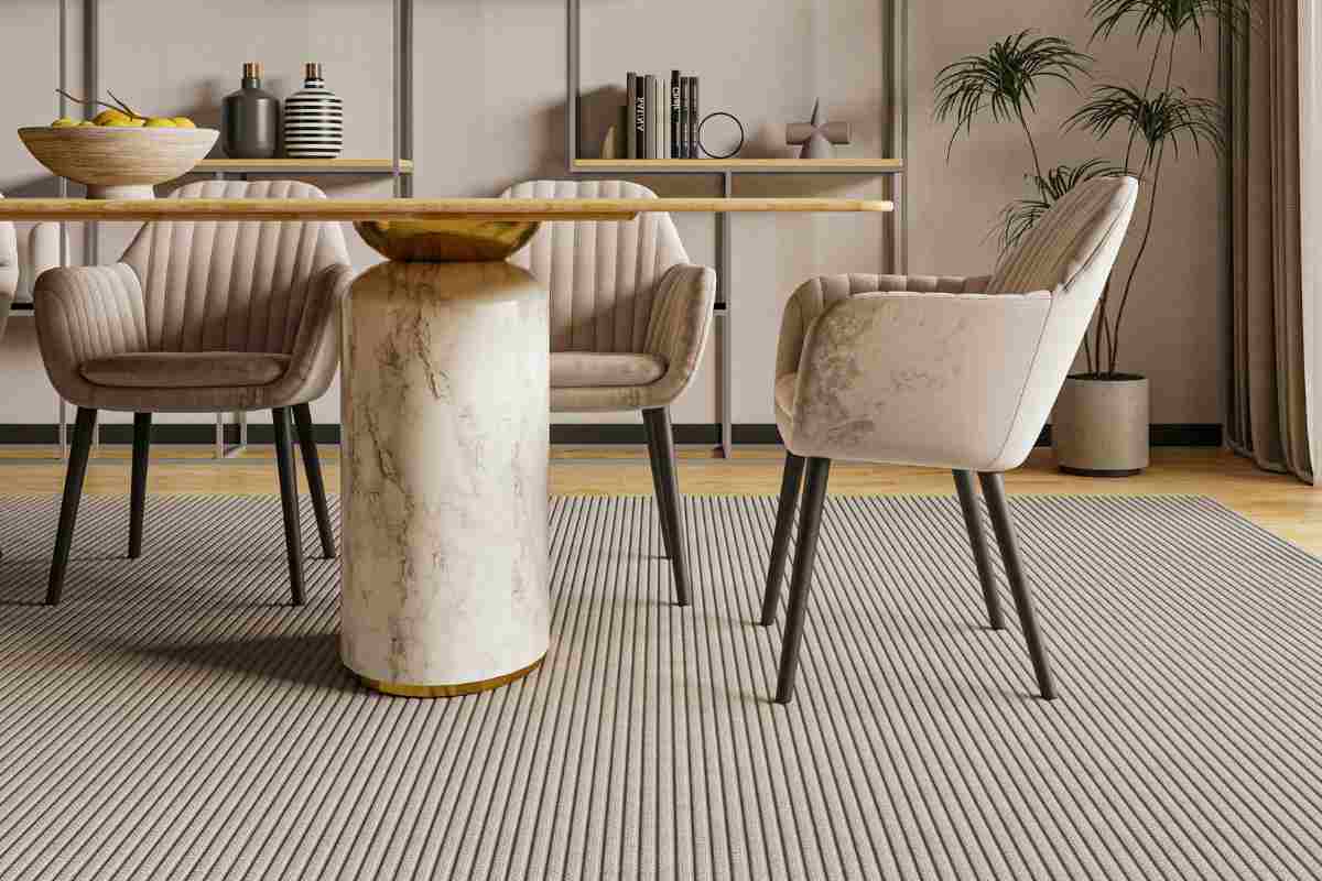 tavolo in legno con gambe cilindriche in marmo e poltroncine arrotondate