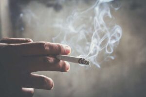 Mano con una sigaretta fumante
