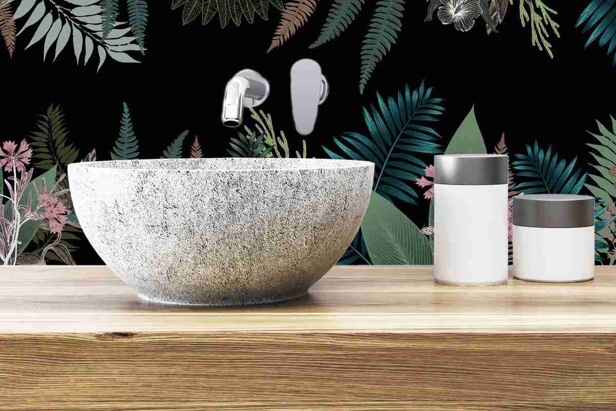 lavabo bagno da appoggio su mensola in legno e dietro un paraschizzi jungle