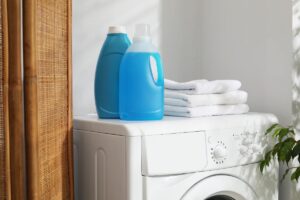 Degli asciugamani e dei prodotti sopra una lavatrice