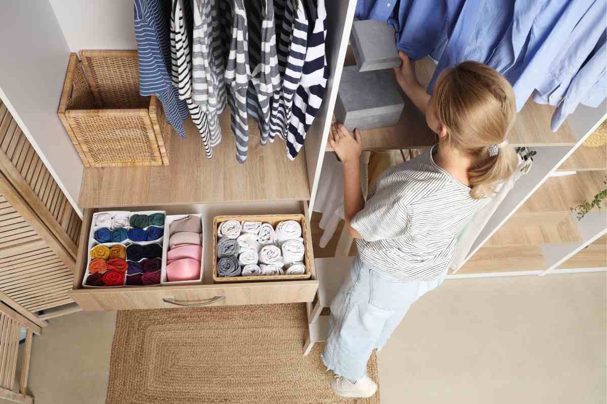 Armadio aperto e donna che guarda dentro l'armadio