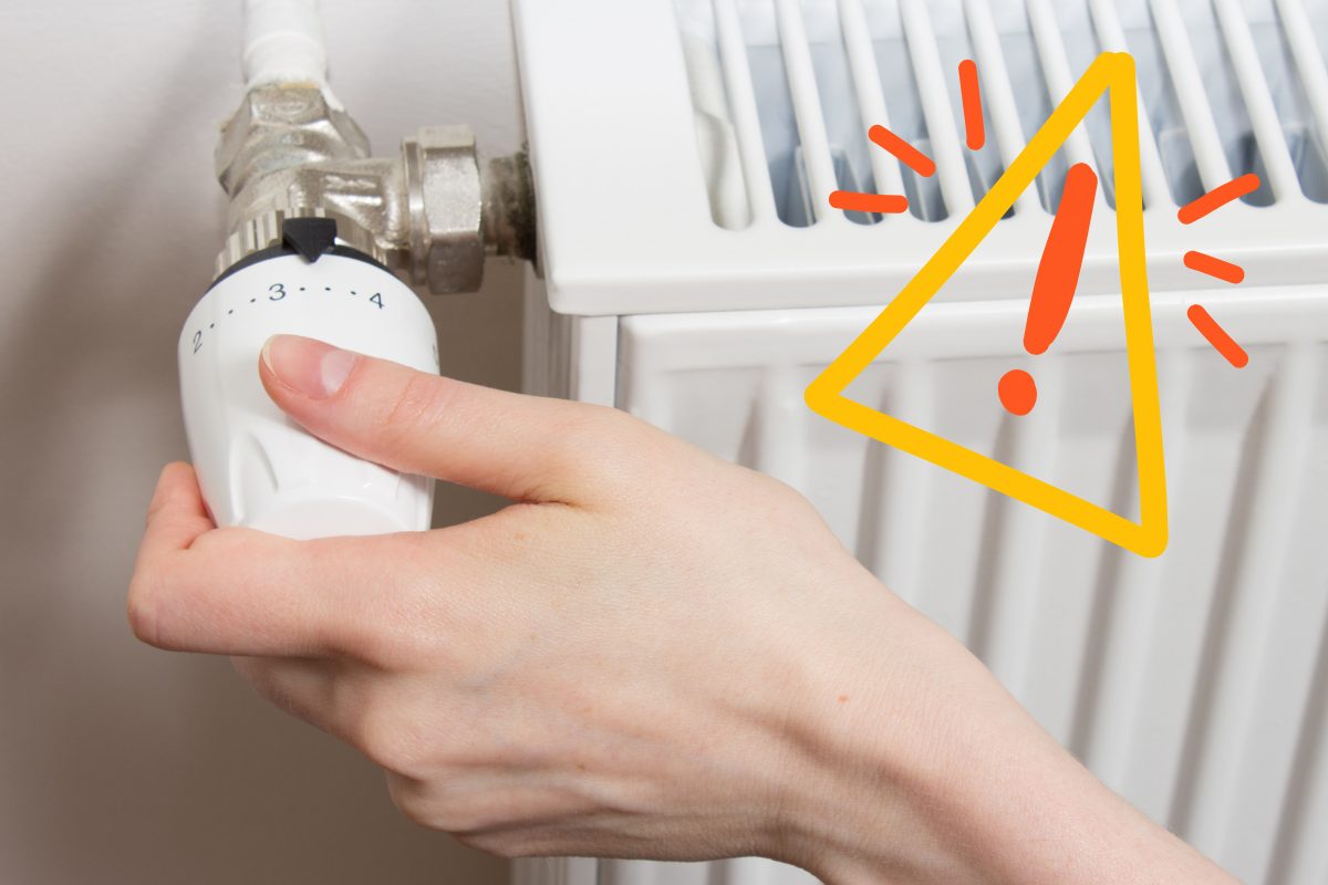 Una persona che accende i termosifoni e un segnale di pericolo in alto a destra