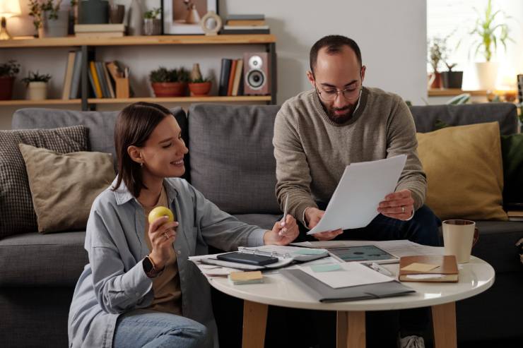 Una coppia che guarda una bolletta con una faccia felice