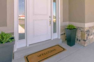 entrata di una casa con piante e zerbino sul pianerottolo