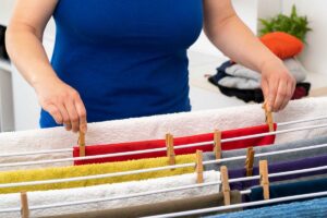 Una signora che sta stendendo dei panni