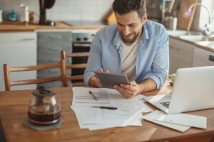 Un uomo che guarda che le bollette ed è felice
