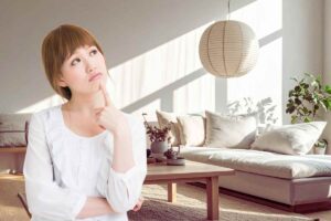 donna che pensa all'arredamento guardando il suo salotto