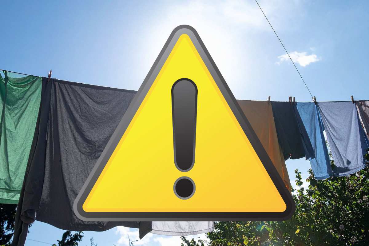 panni stesi al sole e simbolo attenzione giallo