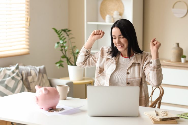Una donna che esulta davanti al computer