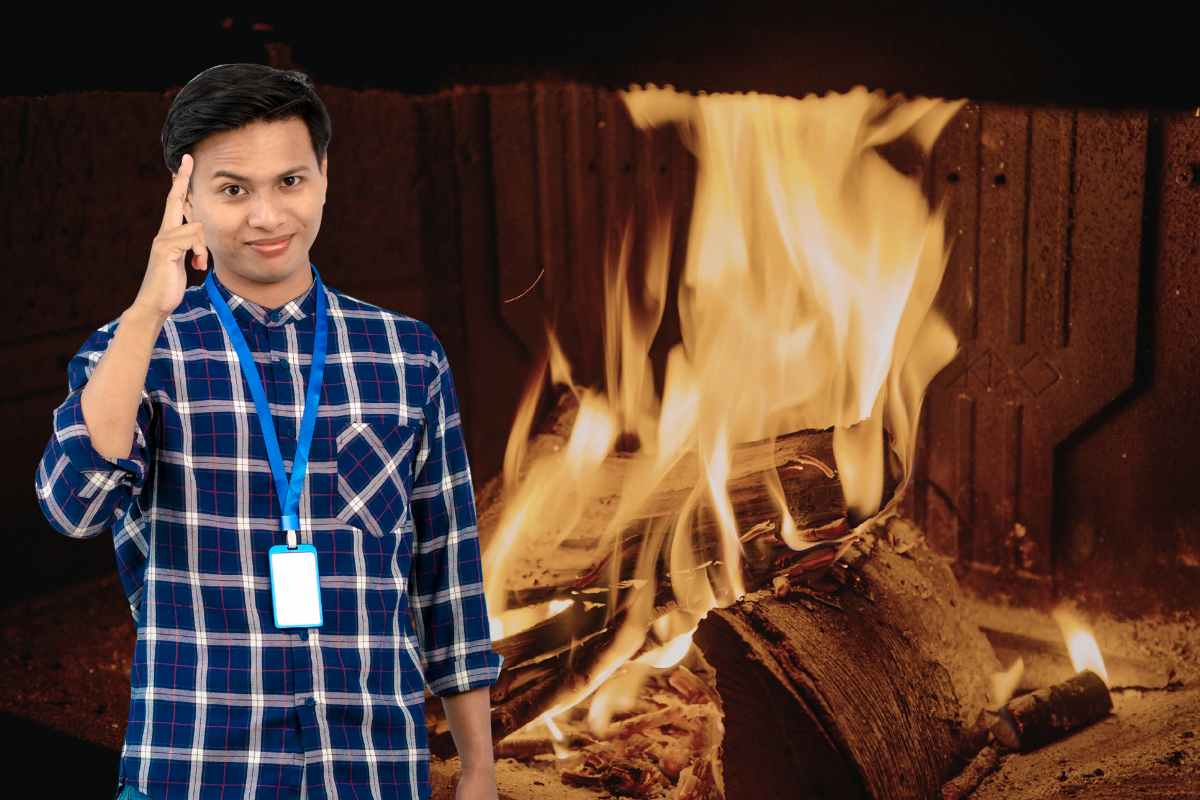 uomo con idea e dietro camino con legna che arde