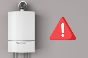 Una caldaia sulla sinistra ed un segnale di pericolo sulla destra