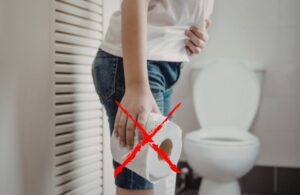 donna in bagno con carta igienica in mano