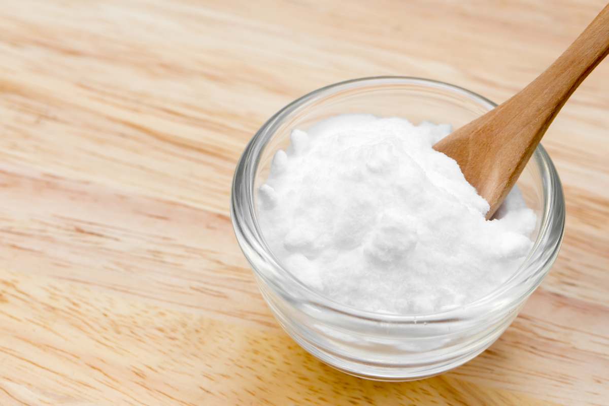 ciotola con bicarbonato e cucchiaio in legno