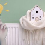 termosifone con casa con sciarpa e mano con lampadina