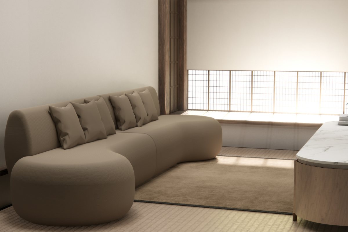 divano marroncino con pareti chiare e forme arrotondate