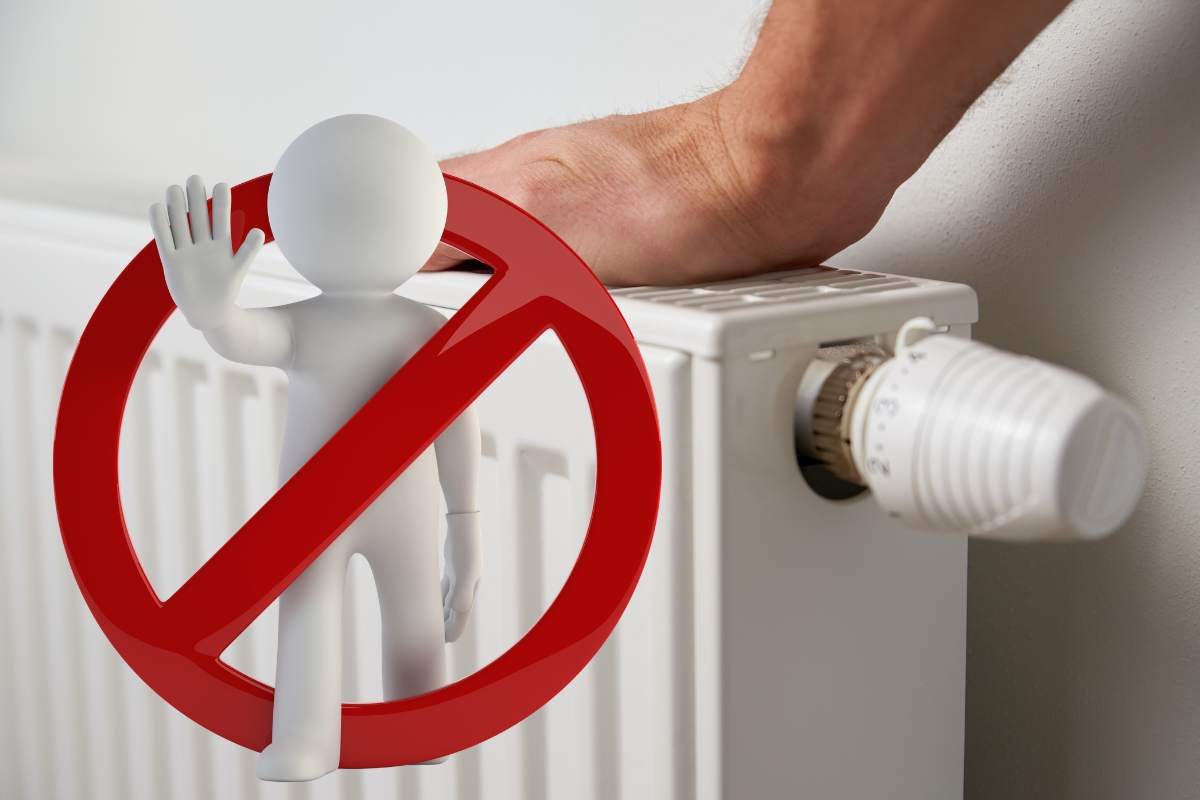 mano su termosifone con omino bianco dentro cerchio rosso per errore