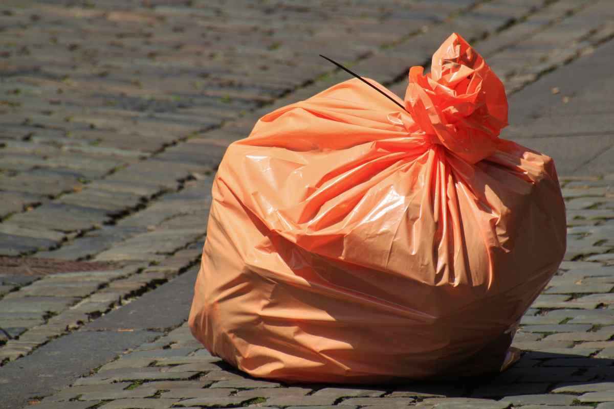 busta arancione con dentro spazzatura