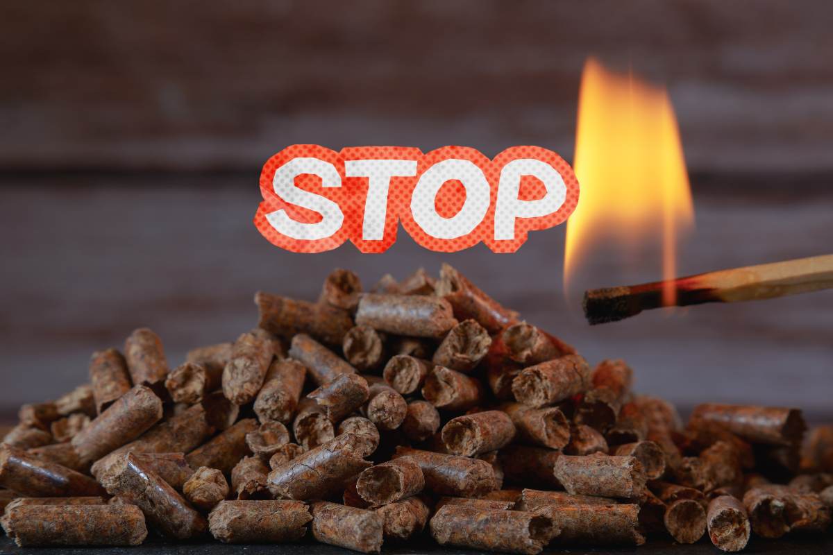 Del pellet che viene acceso con un fiammifero ed una scritta stop in primo piano