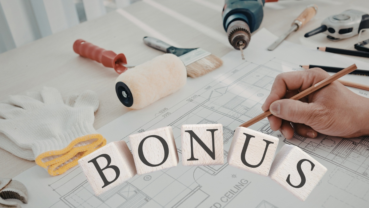 mano che scrive su foglio con oggetti per lavori e scritta bonus al centro