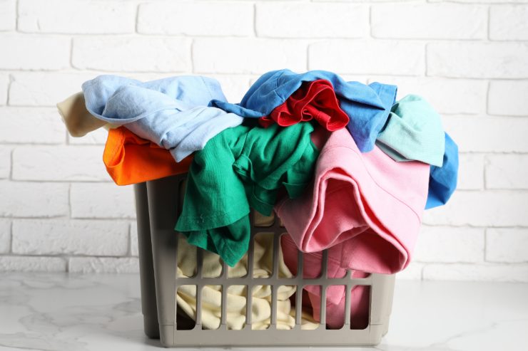 A laundry basket with a few clothes in it