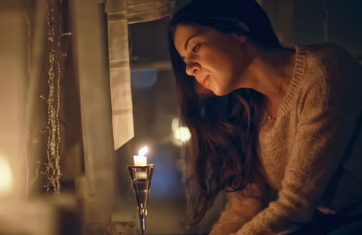 donna in casa con candele 