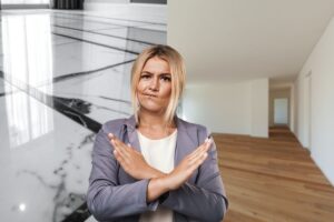 donna che fa no con le mani su parquet e gres porcellanato