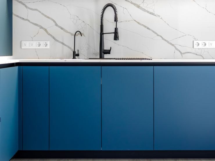 cucina con pensili blu e prese a parete