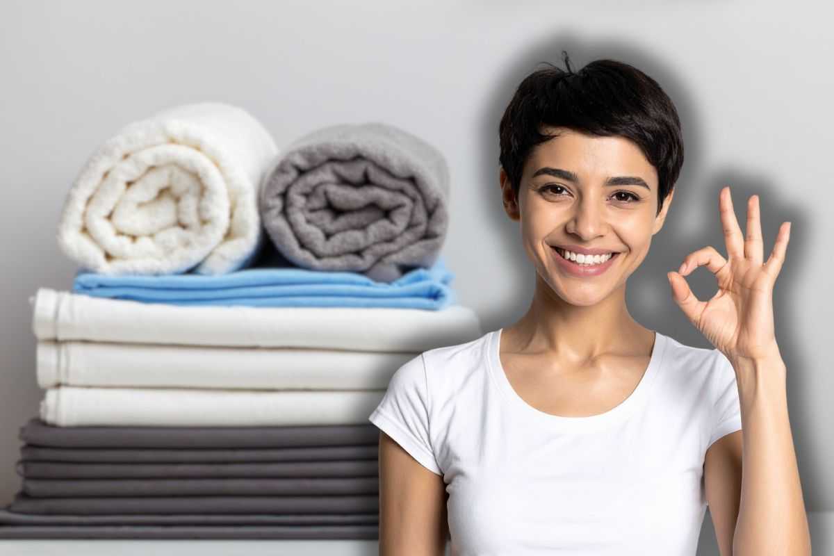 set asciugamani e lenzuola e donna che fa ok con le mani