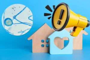 casa con cerchio con all'interno dei germi ed un megafono giallo con simbolo attenzione