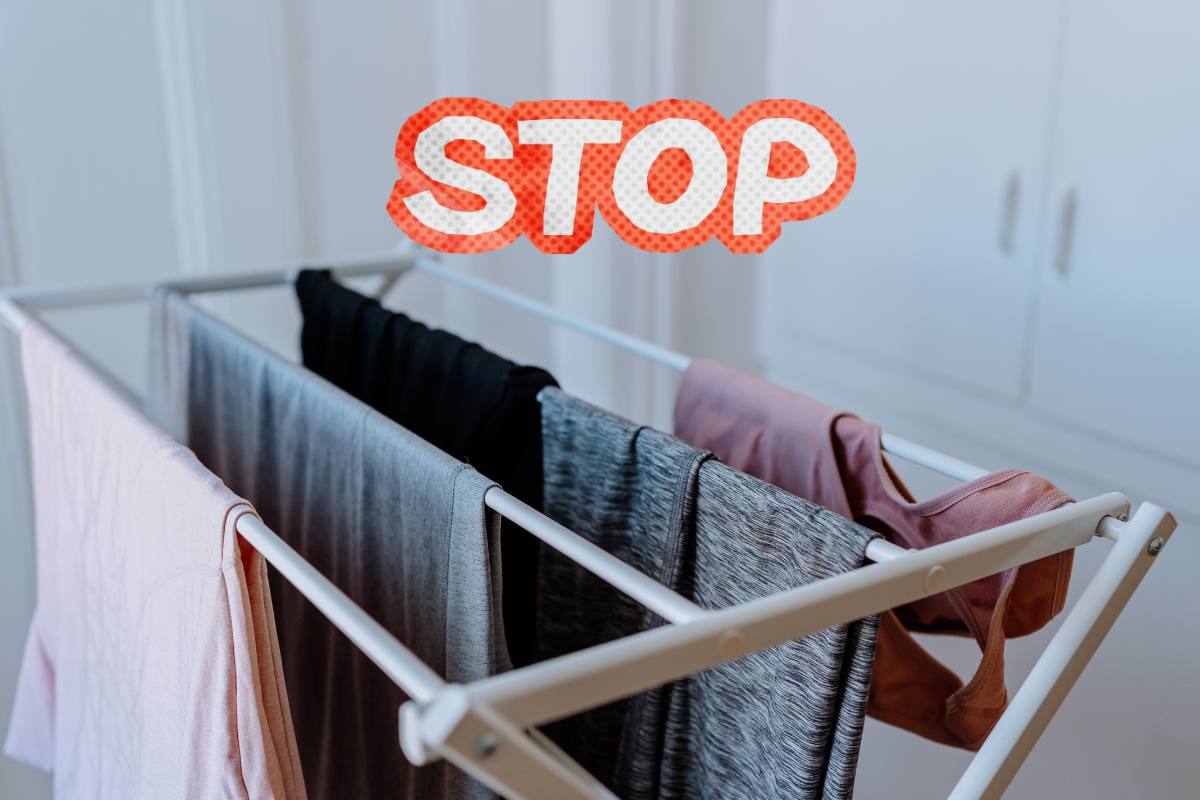 Uno stendino con dei panni sopra e sopra la scritta "stop"