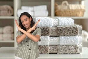 diversi asciugamani piegati e donna che dice no