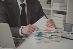 Un uomo che controlla dei documenti, seduto alla scrivania