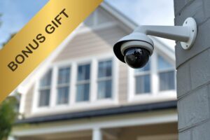 Una casa sullo sfondo, in primo piano una telecamera ed in alto a sinistra una scritta "Bonus gift"