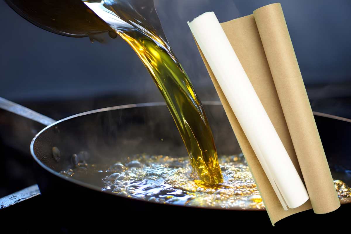 pentola con olio che si versa e rotoli carta da forno 