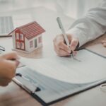 Una persona che firma un contratto di vendita